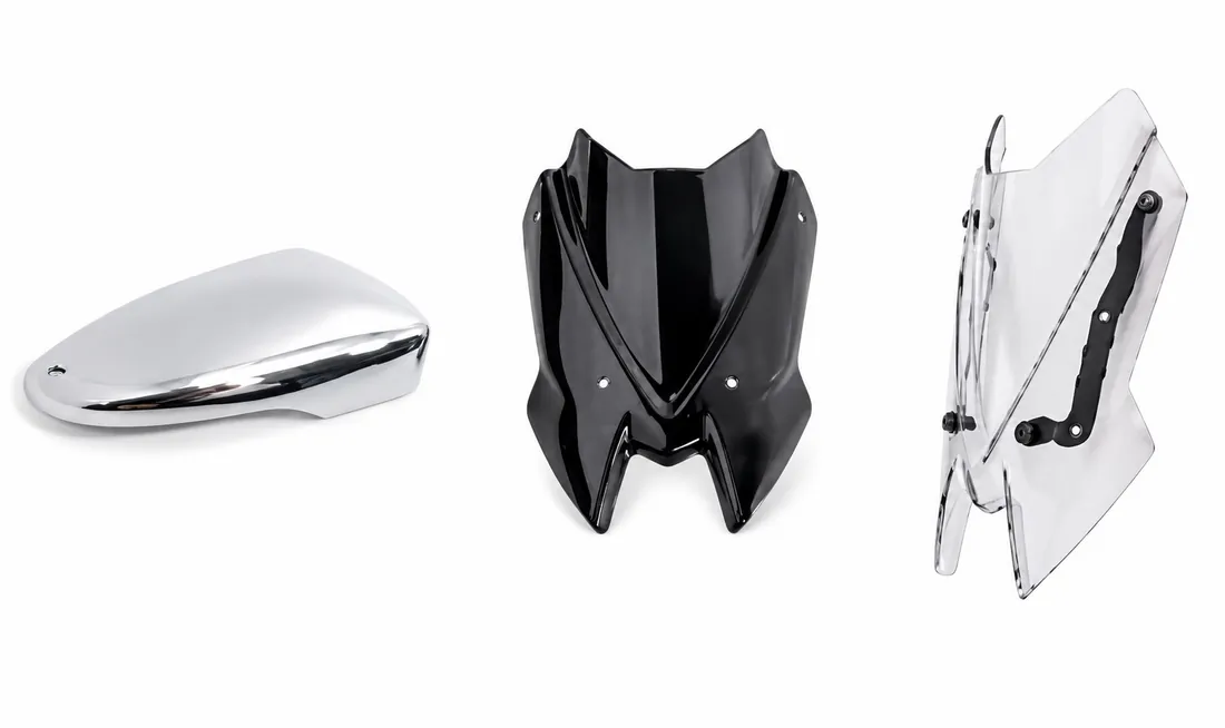Automotive headlight with vacuum metallized reflector and polycarbonate lens