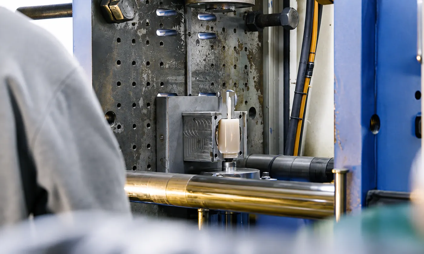 Row of injection molding presses running multi-cavity tooling on the production floor